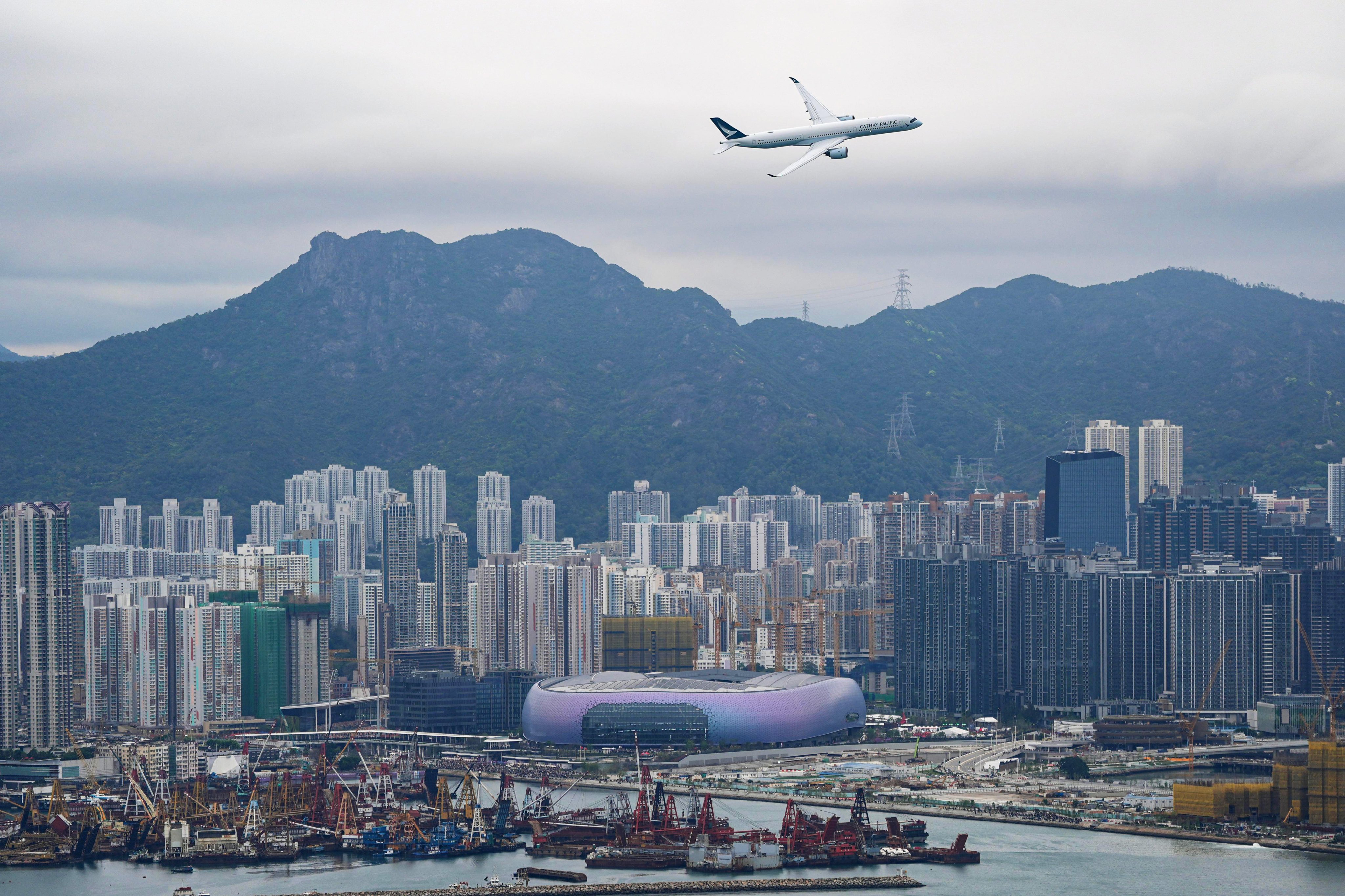 The Airbus A350 plane performs a low-altitude fly-past over Victoria Harbour as part of celebrations for the100th anniversary of the old Kai Tak Airport, now the site of Kai Tak Sports Park. Photo: Eugene Lee
