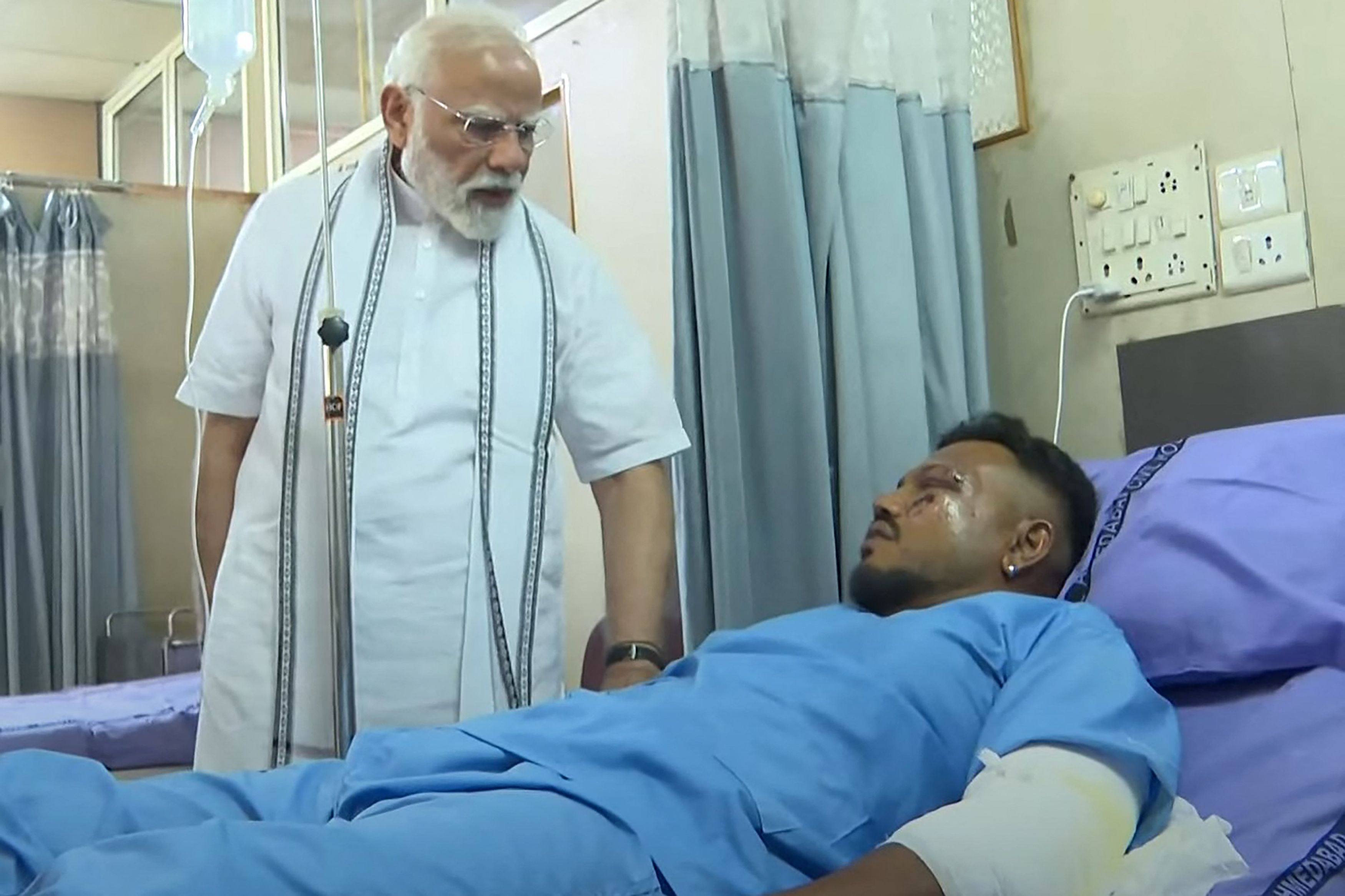 Indian Prime Minister Narendra Modi (left) meets Vishwash Kumar Ramesh, sole survivor of the Air India flight 171 crash, at a hospital in Ahmedabad on Friday. Photo: Narendra Modi Youtube Channel/AFP
