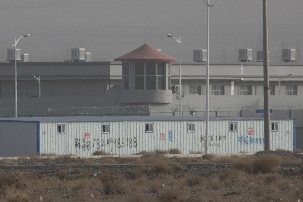 A guard tower and barbed wire fences are seen around a facility in an industrial park in Xinjiang in 2018. Photo: AP