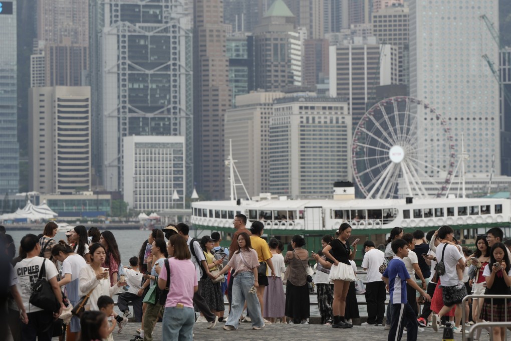 Tourists visit at the waterfront of Victoria Harbour in Tsim Sha Tsui, during the “Golden Week”.  04MAY25 SCMP/ Sam Tsang